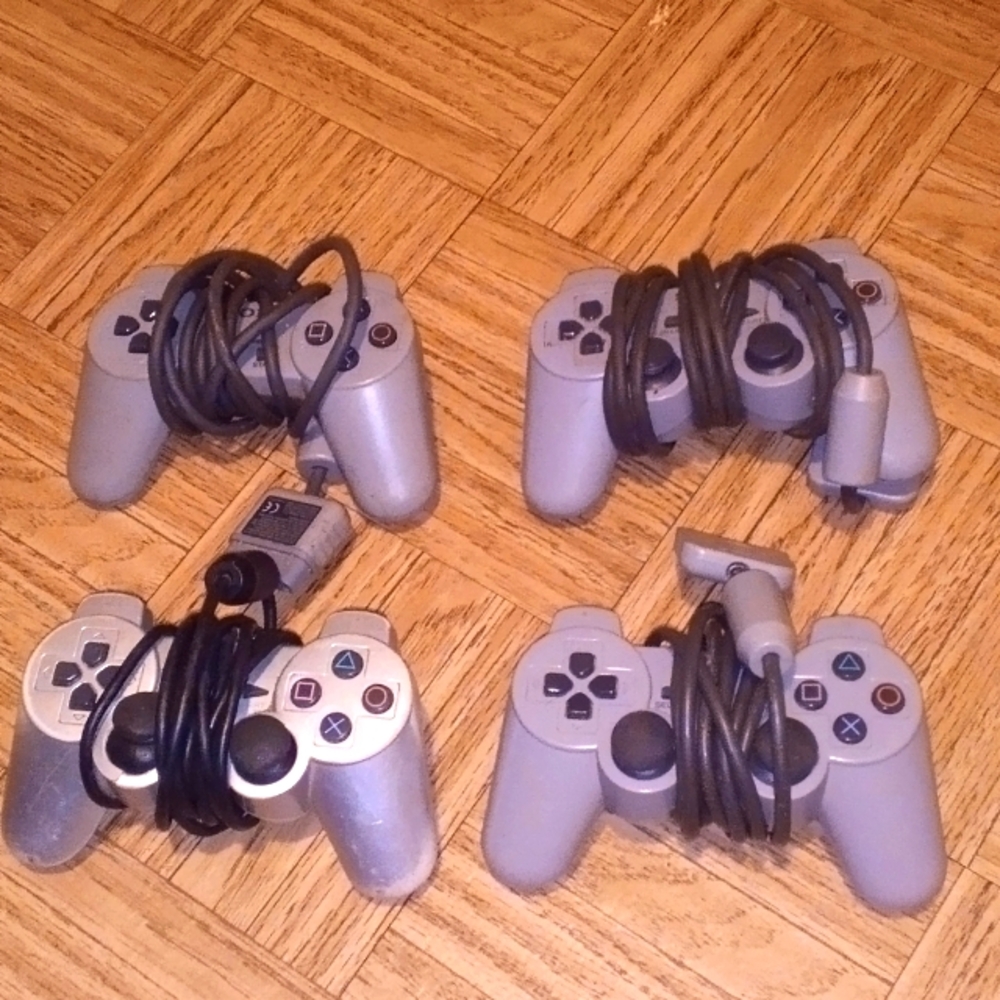 4 grey Sony PlayStation 2 controllers